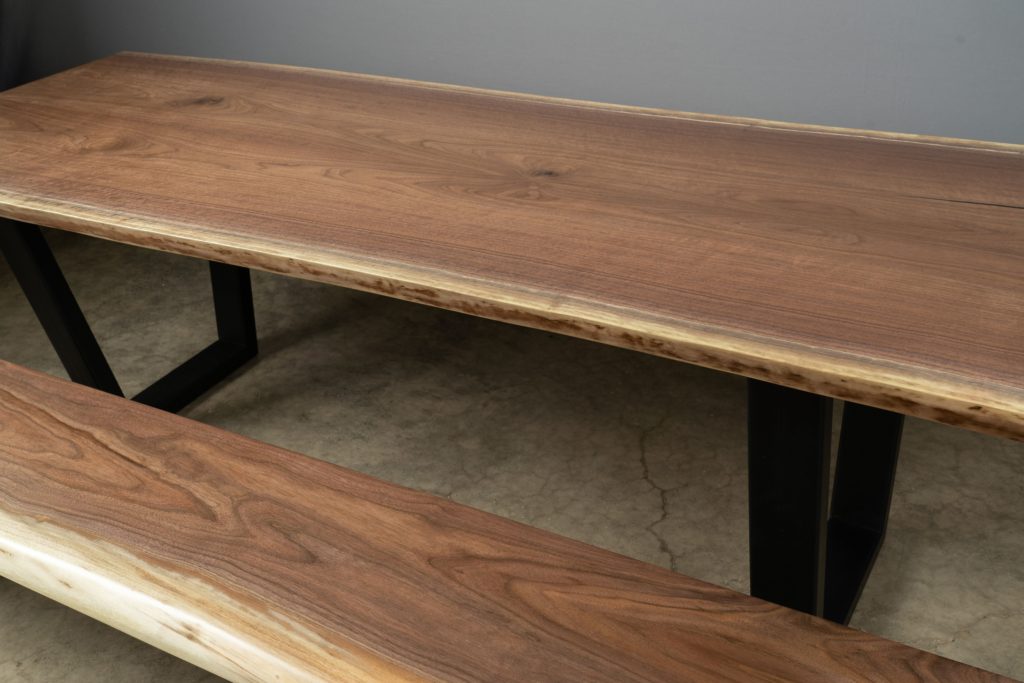 Book matched Black Walnut custom dining table with matching bench